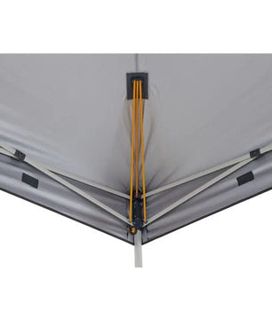 Looking up from underneath the gazebo canopy at the yellow anti-ponding tension rods and the grey metal support frame.