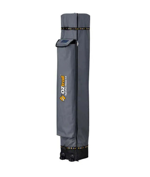 The side profile of the grey OZtrail gazebo carry bag showing the reinforced base and integrated wheels for easy transport.