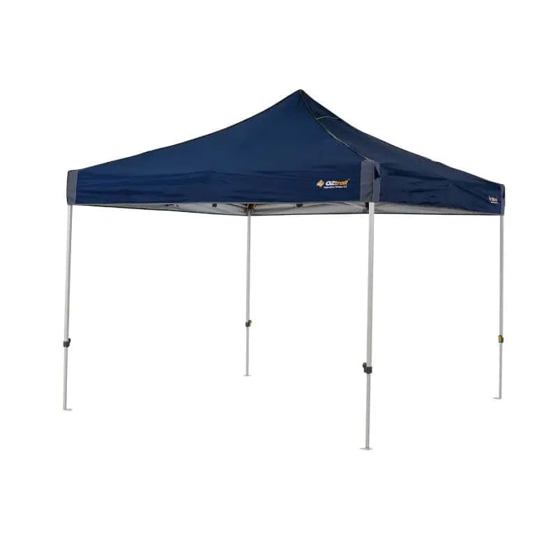 A fully assembled 3x3 meter navy blue OZtrail Hydroflow Deluxe 3.0 portable gazebo with a sturdy grey powder-coated frame.