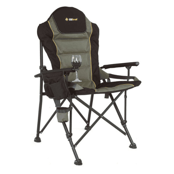 A khaki and black OZtrail Monarch camping chair featuring a tall padded backrest, an integrated side organizer, a cup holder, and a specialized vertical wine glass holder